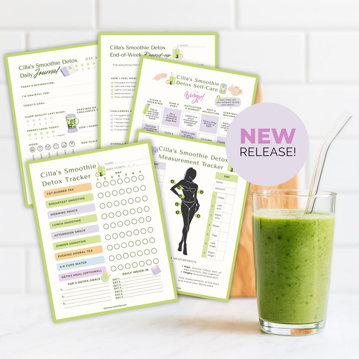 Printable Smoothie Detox Tracker and Journal Pages displayed beside a glass of green smoothie on a kitchen counter